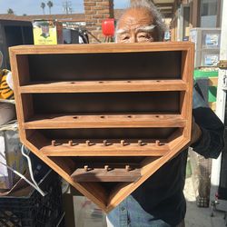 Handcrafted wooden display shelf designed for organizing small cylindrical items