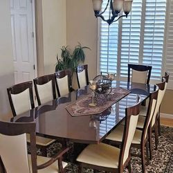 Italian dining table with 10 chairs and a buffet