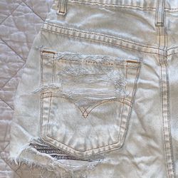White ripped and black stitching high waisted Levi cheeky shorts