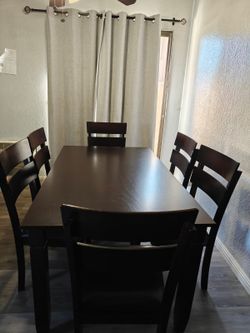 Dark Brown Dining Table with 6 Chairs. Moving soon.