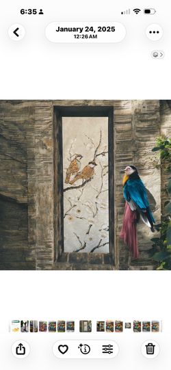 Vertical, nature-inspired wall art piece depicting two  birds finished in gold foil perched on flowering branches, characteristic of traditional East 