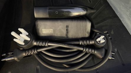 NACS  dual-level portable charger with     interchangeable wall plugs for 120V and 240V charging.