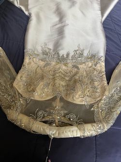 Silver Beaded Sequin Formal Gown it’s for mothers of the bride, the size was 16 but adjusted to size 12 and it’s made by JANIQUE