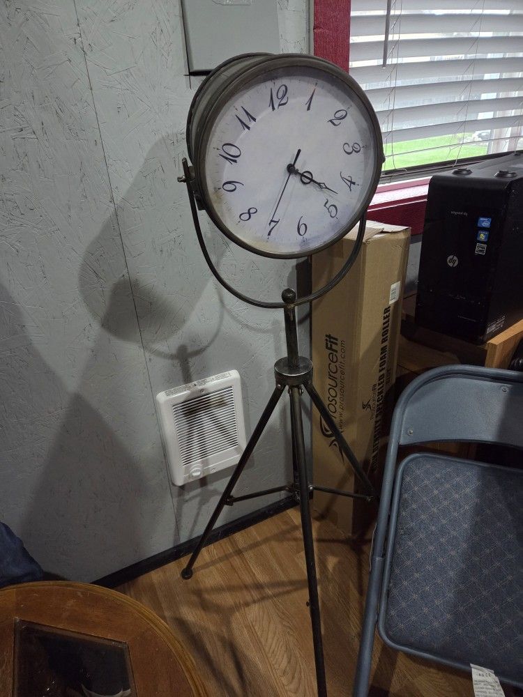 Clock with storage on tripod stand