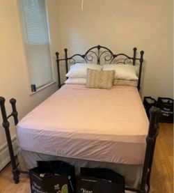 Full size bed with iron headboard and footboard