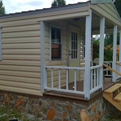 Storage SHED 12-ft wide & 16-ft long man cave with shelves, 4-windows & a front porch.