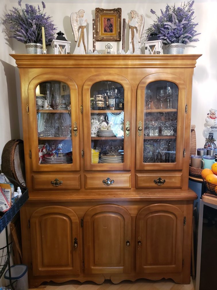 Antique solid wood china cabinet with light inside.Pending pickup.
