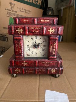 A reddish-brown, antique-style mantel clock