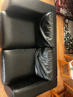 Black faux leather sofa and love seat