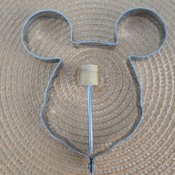 The Mickey Mouse Metal Mold with Handle is a charming and practical kitchen tool perfect for creating Mickey Mouse-shaped pancakes, and eggs.