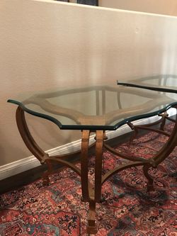 Two iron and glass end tables