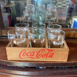 7 Coca Cola Glasses And Holding Crate.