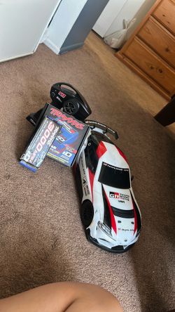 Traxxas car plus a charger and 2 batteries and controller