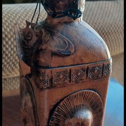 Primal leather wrapped decanter.