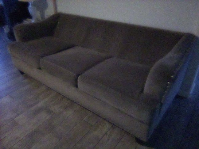 Grey upholstered couch in good condition. 87" wide