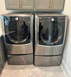 LG front load washer and dryer with mini washer pedestal and storage ped