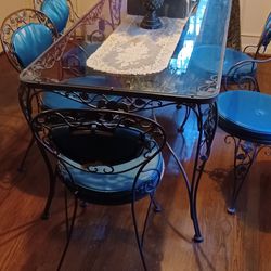Charming Glass Top Table And Chairs..end Chairs Have Arm Rests..The Metal Table And Chairs Are Leaf And Rose Design..Comfortable Seat And Back Pads ..