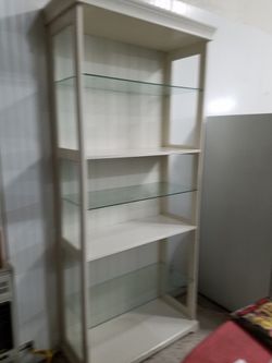 Tall white unit with glass shelves