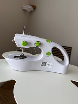 Hand held sewing machine