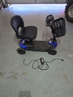 4 wheel electric scooter w/ charger cord and front basket carry things