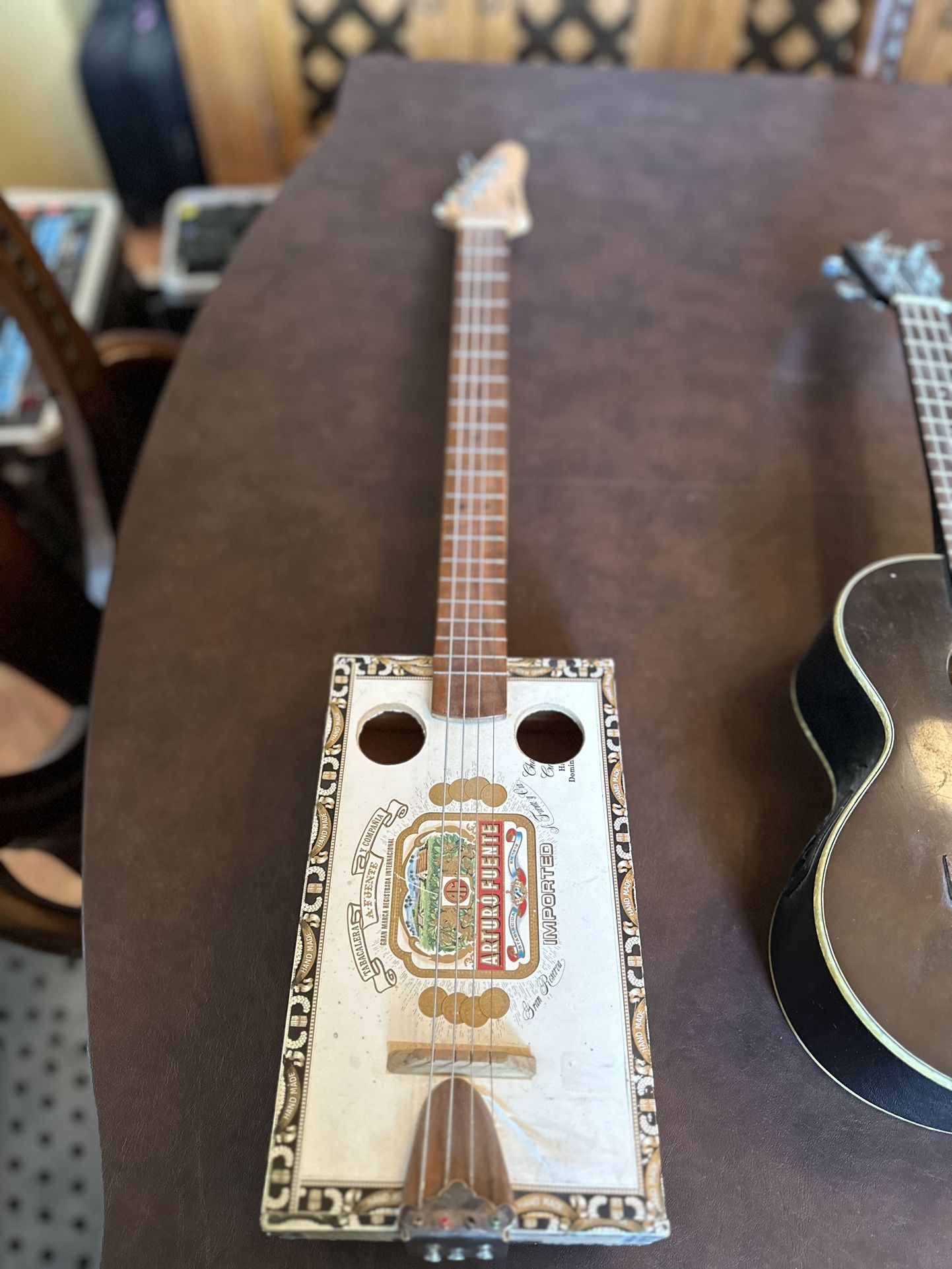 Cigar box guitar and Ukulele with case. 