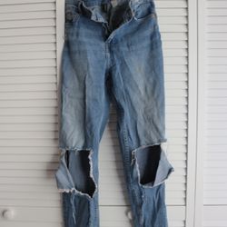 High-waisted, straight-leg blue jeans with a distressed look