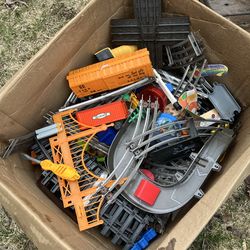 Boxes of vintage model train cars and tracks