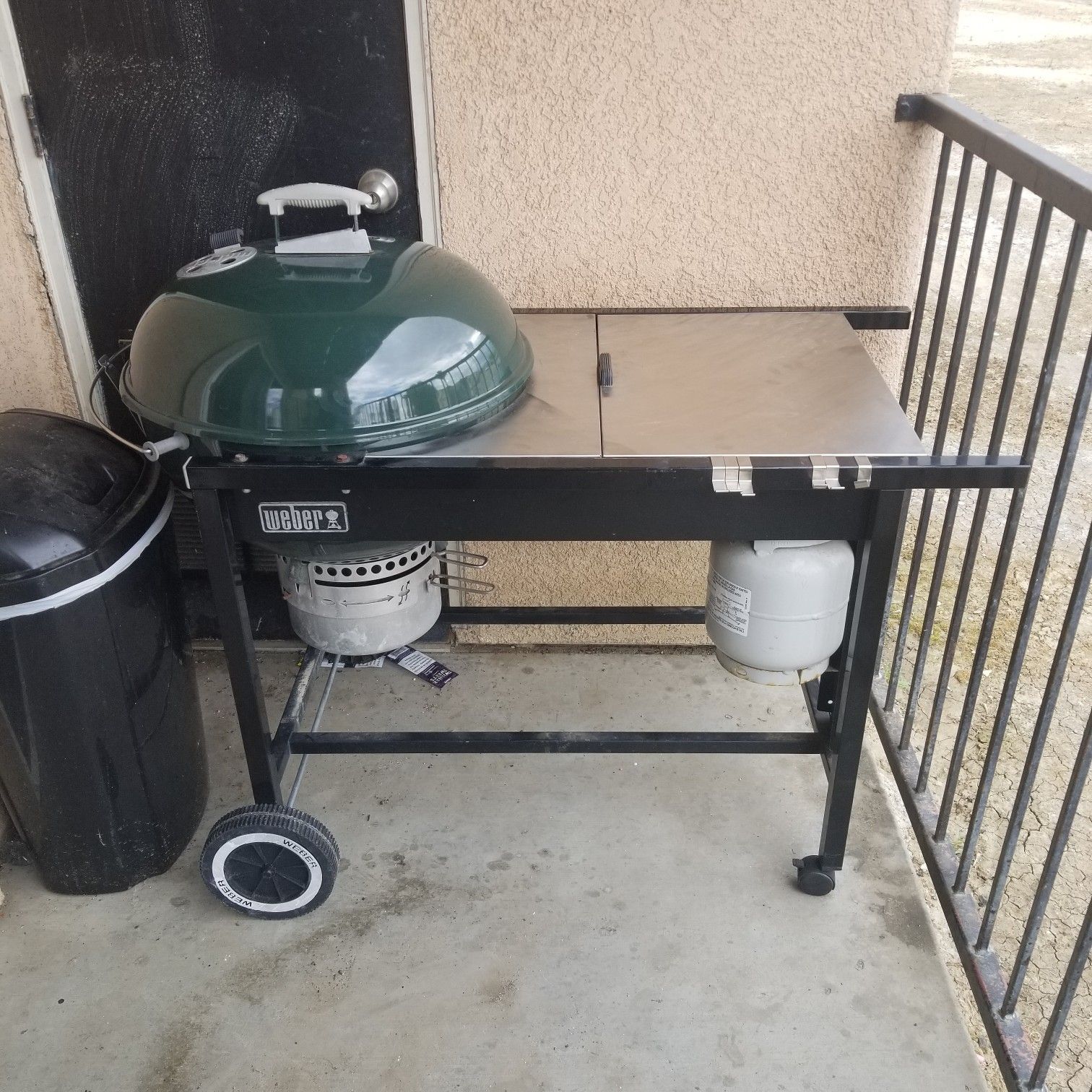 Weber BBQ grill with table and open up storage.