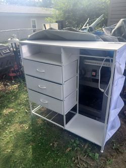 Closet organizer solid wooden cabinet with 3 drawers 1 shelf a place to hang clothes and plug outlet and storage on both sides