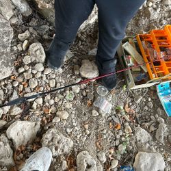 Tackle Box With Bait And Equipment In It With A Rod With No Reel