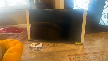 Large Flat Screen TV with Remote with a cracked screen