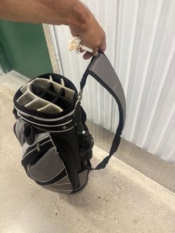 Pre-owned Tommy Armour golf cart bag in gray and black. It is designed with a multi-way divider for club organization and multiple zippers $50