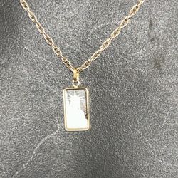 18 in.² silver solid rope chain with a 14 karat holding a 1 g platinum bar
