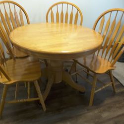 42" round Table With 15" Drop Leaf In Center And 4 Chairs