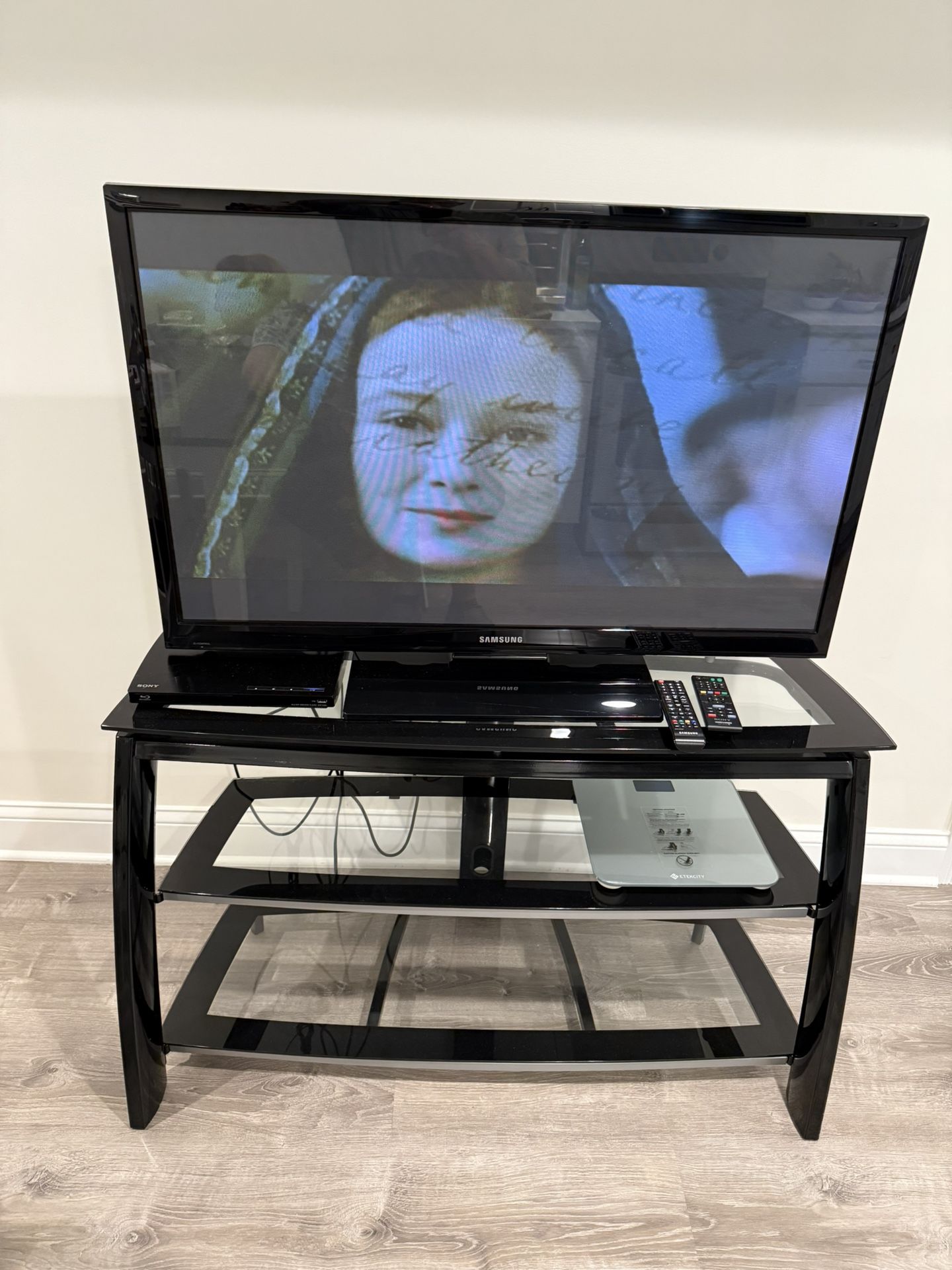 45 Inches Samsung Television With Remote Control And Tv Stand With Three Glass Shelves . It Has 2 HDMI And 1 USB Port. $100.00 Or Best Offer For Both