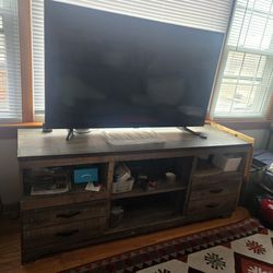 TV stand, which features a rustic finish, plank-style details,