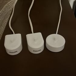 Three Philips Brand Sonicare  toothbrush chargers 6100  and 4100 models. Original ones.