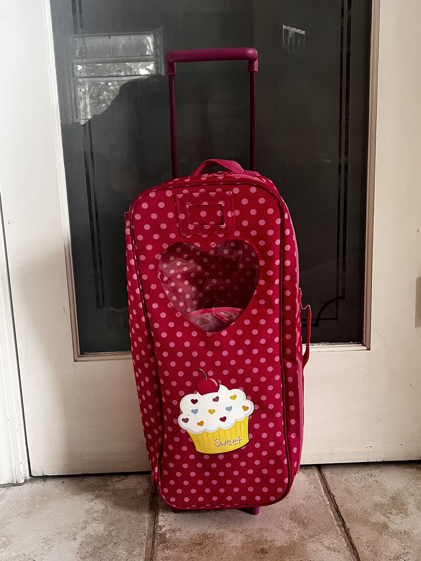 DOLL CARRIER WITH HANDLE AND ROLLS ON WHEELS - PINK , NEW CONDITION