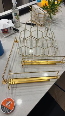 Wine bottle holder, two under cabinet wine glass holders and a small towel bar. Golden.