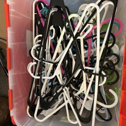 Plastic Hangers In Plastic Tub.  You Get 66 Hangers Total.  