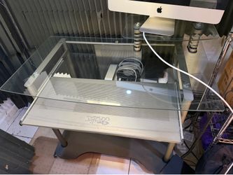 Glass desk with sliding keyboard stand.