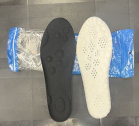 Pair of black and white shoe insoles.