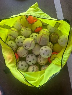 Assorted practice and baseballs with bag.