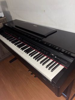 Selling a Williams digital piano in black. It has a full-size keyboard, built-in controls/speakers, and a nice classic piano-style design.