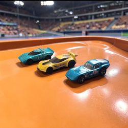 (Lot Of 3) Assorted Hot Wheels/ Shelby Cobra/ Lancia Stratos/ Chevrolet Corvette Die-Cast 1:64. The image contains three Hot Wheels die-cast toy cars,