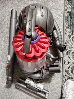 Dyson DC39 Multi Floor Canister Vacuum is shown disassembled with its core attachments.