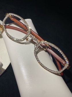 One (1) Millionaire Celebrity French Unisex wooden frame with sparkling lab, diamond ice trim. Comes with a white protective case for secure storage. 