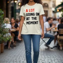 A Lot Going On At The Moment” Graphic Tee – Beige Statement Shirt – Size Large