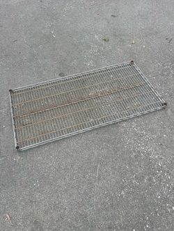 Rack - 2’ x 4’ Heavy Duty Metal Shelving in Fair Condition. Not Bent, Simply Normal Outdoor Use.