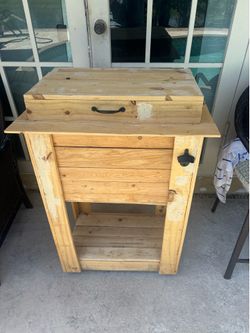 Wooden rolling outdoor patio cooler with bottle opener and spout